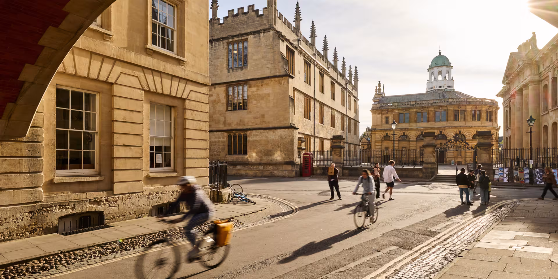 Cyclists passing under Hertford College's Bridge of Sighs in Oxford